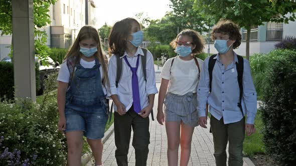 Group of Schoolchildren in Medical Masks To Protect Against Coronavirus.