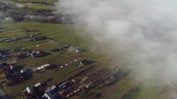 Low clouds over Chochołów village, Poland. Aerial forward