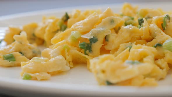 Omelette with scallion on ceramic plate slow panning 4K 2160p UHD footage - Beaten eggs with young f