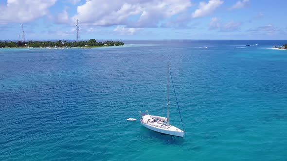 Wide angle drone copy space shot of a white paradise beach and blue water background in hi res 4K