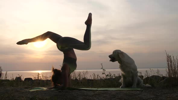 Strong Woman Doing Stand Upside Down at Sunset