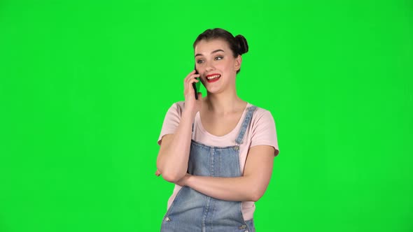 Portrait of Smiling Girl Talking for Mobile Phone and Rejoice on Green Screen