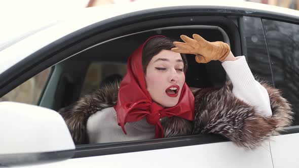 Stylish Woman Looking Out of Car Window in Winter