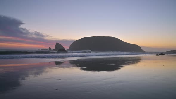 Tranquility and peaceful atmosphere at beach in Brookings, Oregon. Colorful sunset sky with clouds.