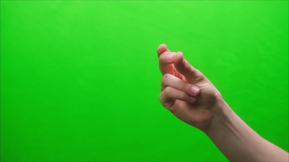 Closeup of a Hand Gesture on a Green Background Clicking with Fingers Shooting a Gesturing in Studio