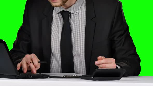 Businessman Signing Documents on Reflective Table. Green Screen