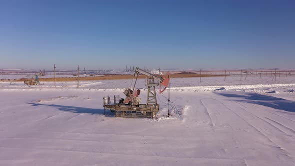 Pump Jack in Vast Oil Fields in Winter