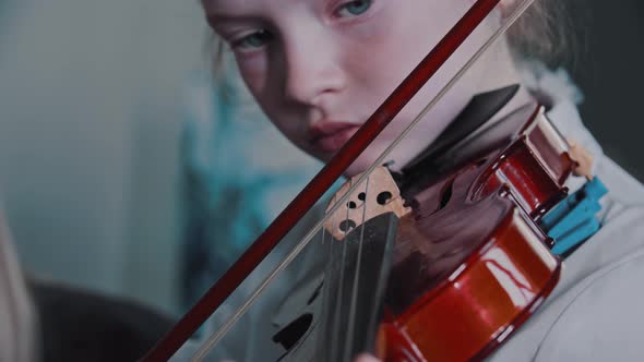 Tired Cute Girl Playing Violin During Lesson in the Class