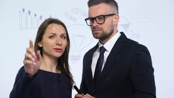 Man and Woman Rejoice in Success and Having Fun in a Modern Glass Office