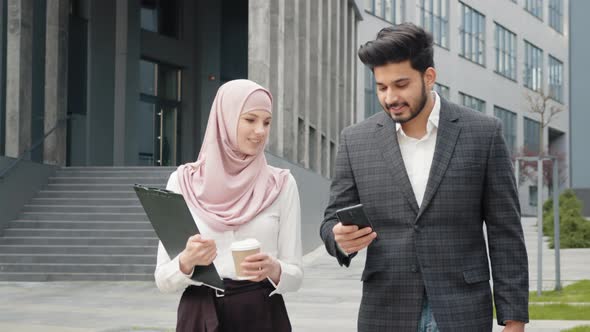 Arabian Business Colleagues in Formal Clothes Walking on Street and Discussing