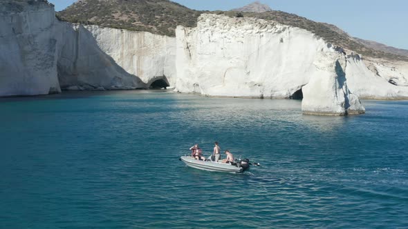 Three Young Adults on Boat Trip Aerial Follow Shot