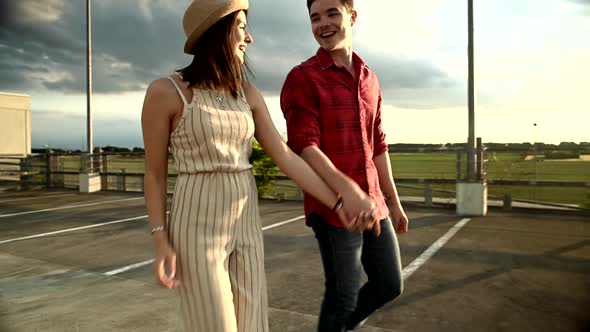 Young couple walking on parking deck