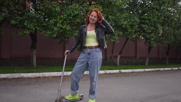 Wide Shot Joyful Caucasian Retro Woman Dancing Listening to Music in Headphones Standing with