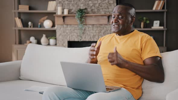 African American Male Senior 50s Man Working Laptop at Home Talking Online to Lovely Sweetheart