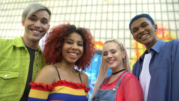 Glad Group of Multiracial Teenagers in Colorful Trendy Clothes Smiling Camera