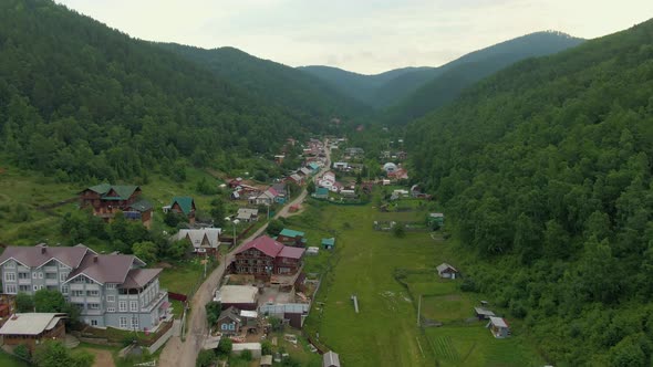 Flight Over the Village Between the Forest Hills