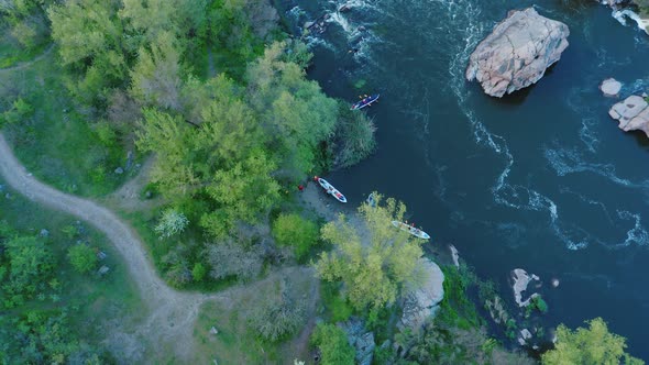 A Topdown Aerial View of the Rowers Disembarking From Boat Races on the River