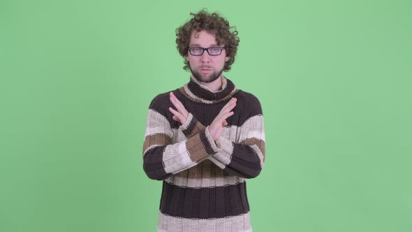 Serious Young Bearded Man Showing Stop Gesture