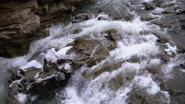 Wild Mountain River Flowing with Stone Boulders and Stone Rapids. Slow Motion