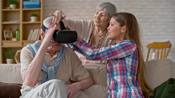 Young Woman Explaining Virtual Reality to Grandfather