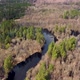 Aerial view of the river between the pines. Flying over a winding riverbed surrounded by treetops - VideoHive Item for Sale