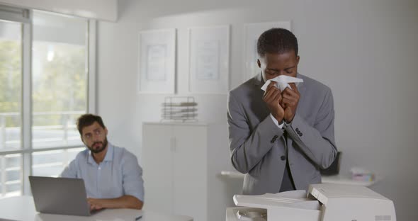 Sick Afro Manager Blowing Nose in Paper Napkin Working in Office