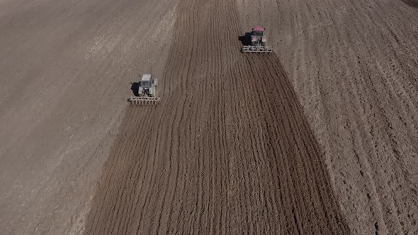 Tractors Plows the Field Before Sowing Seeds on a Spring Sunny Day