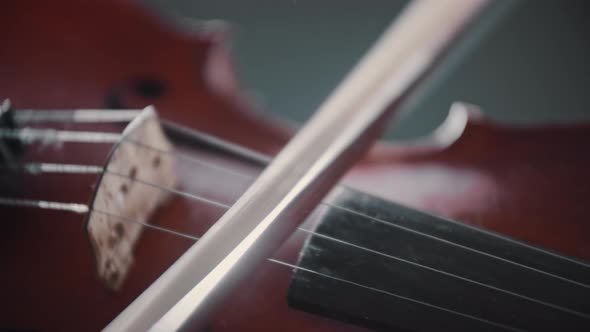 Young Woman Playing Violin  Playing with a Bow on the Strings  Rosin Crumbs Under the Strings