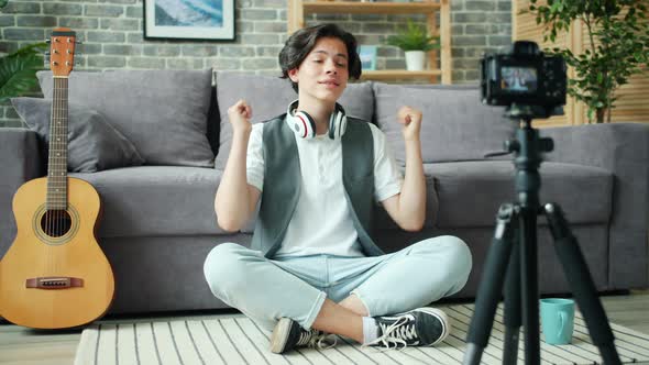 Handsome Teenager Showing Thumbs-up Recording Video for Internet Vlog at Home