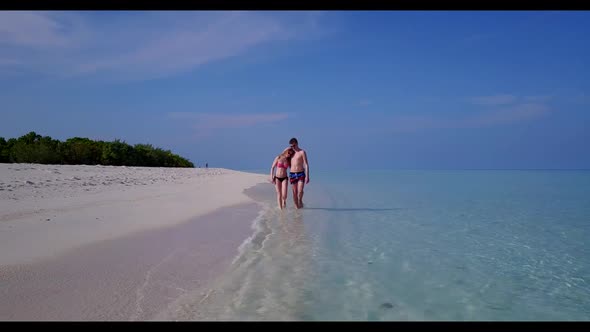 Guy and girl relax on idyllic sea view beach trip by blue water and clean sandy background of the Ma