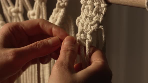 A Woman Makes a Rope Craft in a Creative Workshop