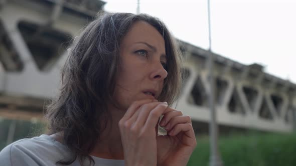 Portrait of a Brunette Under a Railway Bridge