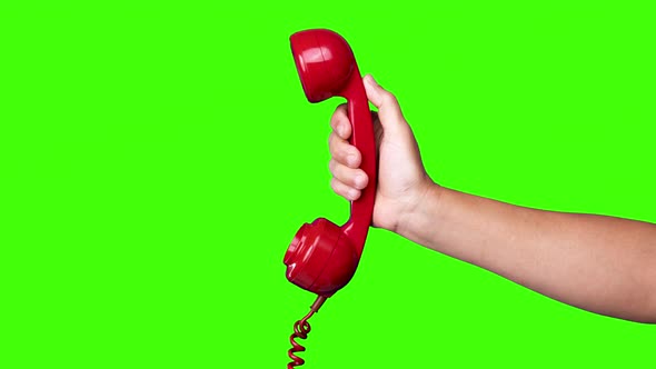 Hand Holding the Receiver of a Retro Red Telephone