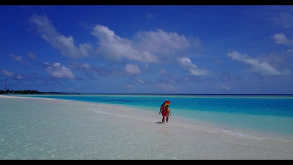 Boy and girl sunbathe on marine sea view beach adventure by aqua blue ocean and white sandy backgrou