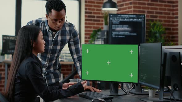 Mixed Team of Programmers Analyzing Source Code Looking at Green Screen Chroma Key Mockup