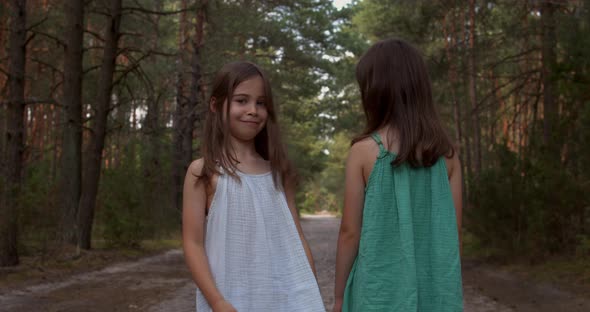 Two Beautiful Girls Walking in the Woods