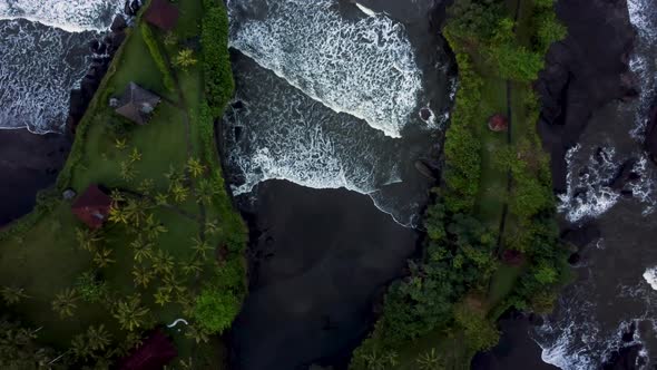 Top down view on lagoon with black sand