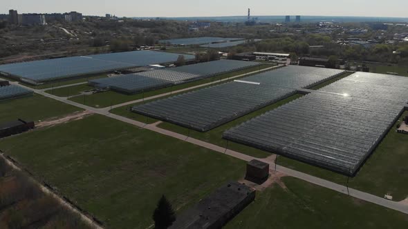 Camera Fly Over the Greenhouses. Aerial Shot. Geometry in Industrial Production. Perfectionism in