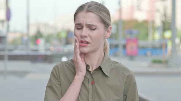 Discomforted Woman with Toothache Standing Outdoor