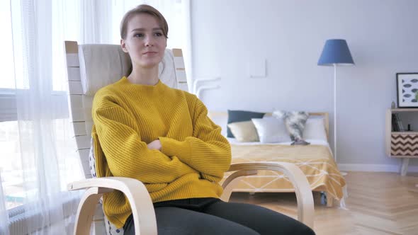 Pensive Woman Relaxing on Chair and Looking at Roof