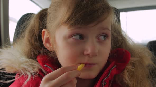 Child Girl Eating In The Car