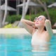 Young asian woman enjoy around outdoor swimming pool for leisure - VideoHive Item for Sale