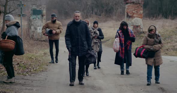 Sad Homeless Refugees Walking While Migrating During War