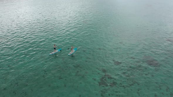 Surfers Couple on Surfing Board Man and Woman Swimmers Relaxing on Blue Surfboards Top View