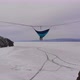 Man Hanging in Hammock Above By Ice of Frozen Lake Baikal - VideoHive Item for Sale