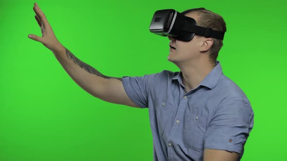 Man Using VR App Helmet To Play Simulation Game, Drawing. Guy Watching Virtual Reality 3d Video
