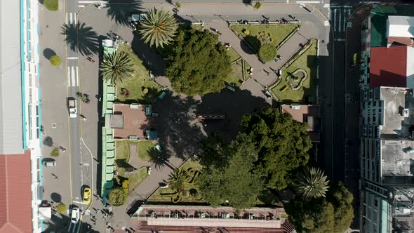 Overhead View Of Parque la Basilica And Vehicles Driving In The Street At Baños de Agua Santa, Ecuad