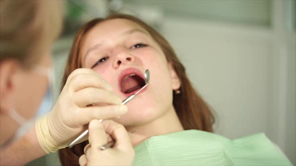 Orthodon Checks the Teeth of a Teenager Who Has Come to the Clinic for Treatment