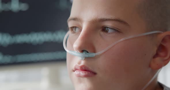 Close Up Portrait of Bald Kid Patient with Nasal Tube in Hospital Ward