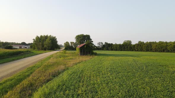 Old shack in the middle of a grassland, field, farm in Minnesota during a sunny summer afternoon